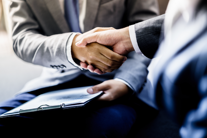 businessman shaking hands to seal a deal with his partner