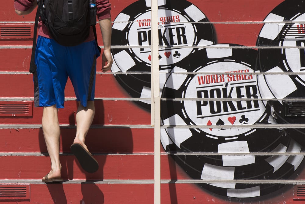 man walks up steps showing WSOP logo