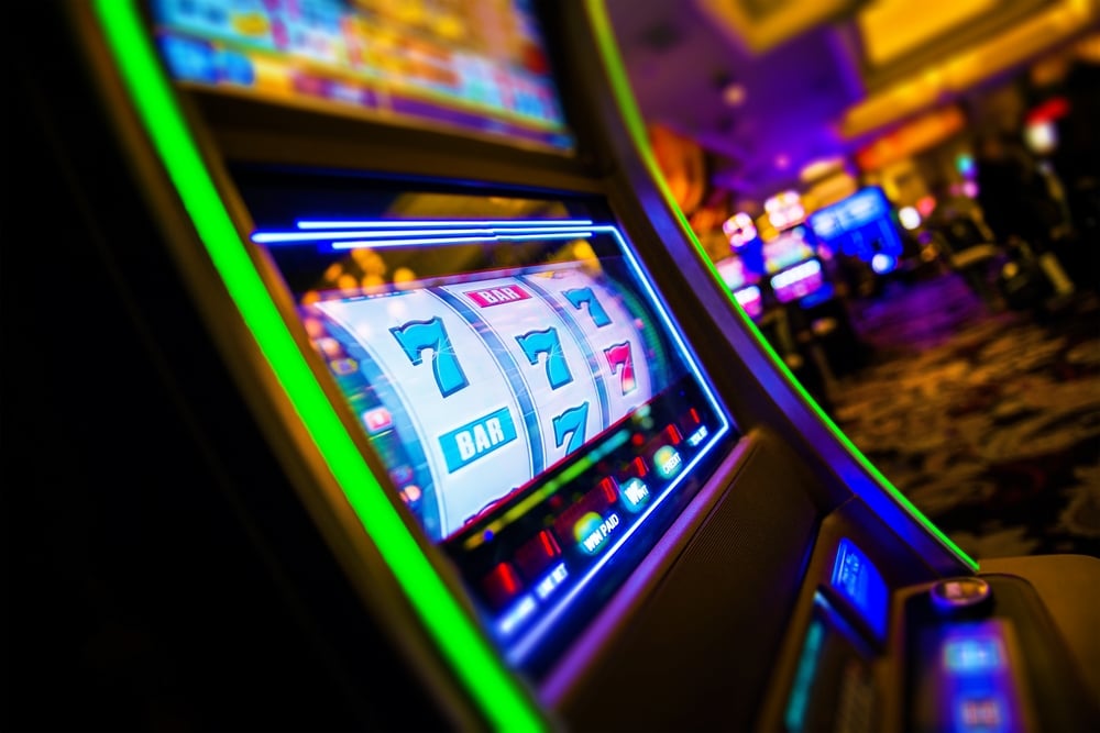 777 land on slot machine reels inside gambling establishment