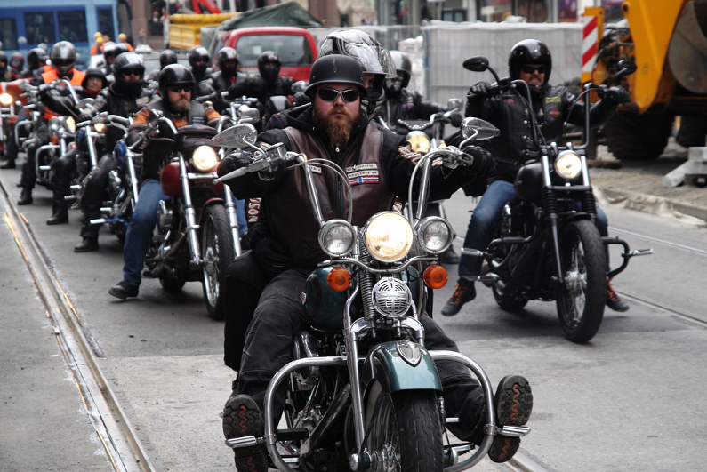 bikers riding through a street