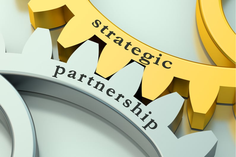 Two interlocked gears labeled "strategic" and "partnership"