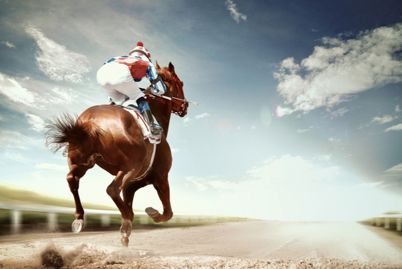 Jockey riding a horse alone