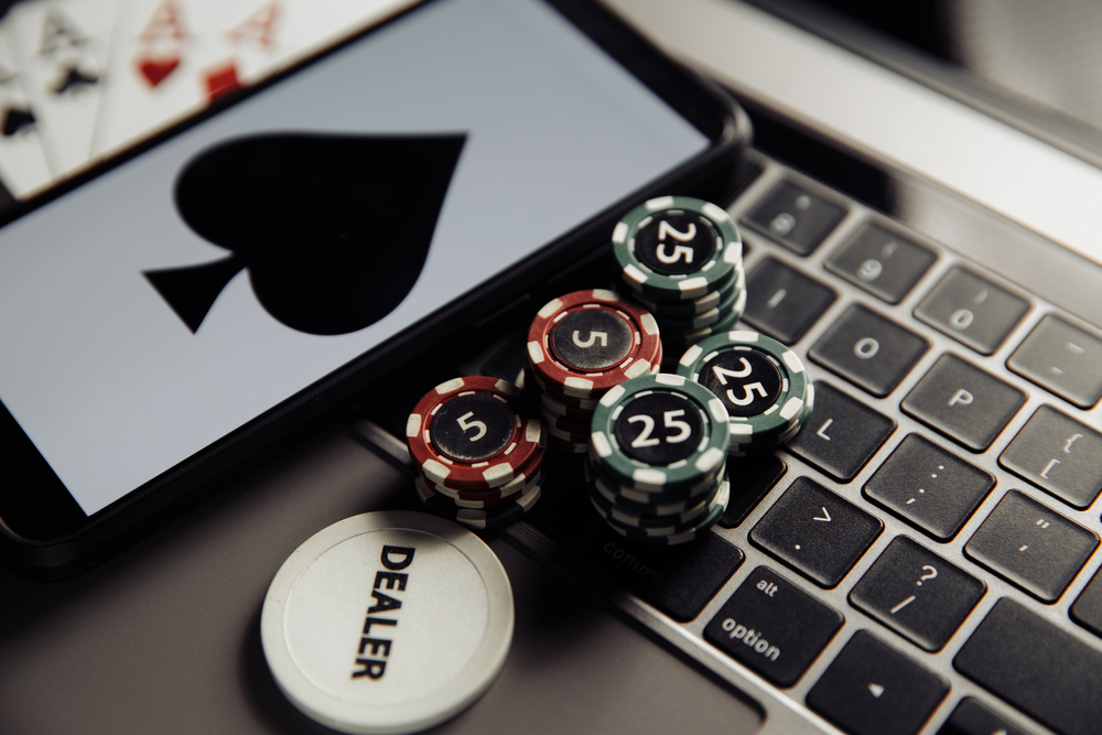 Ace card and only poker chips on laptop keyboard