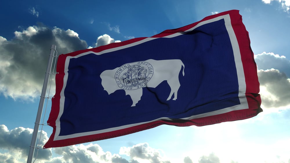 flag of Wyoming against blue sky backdrop